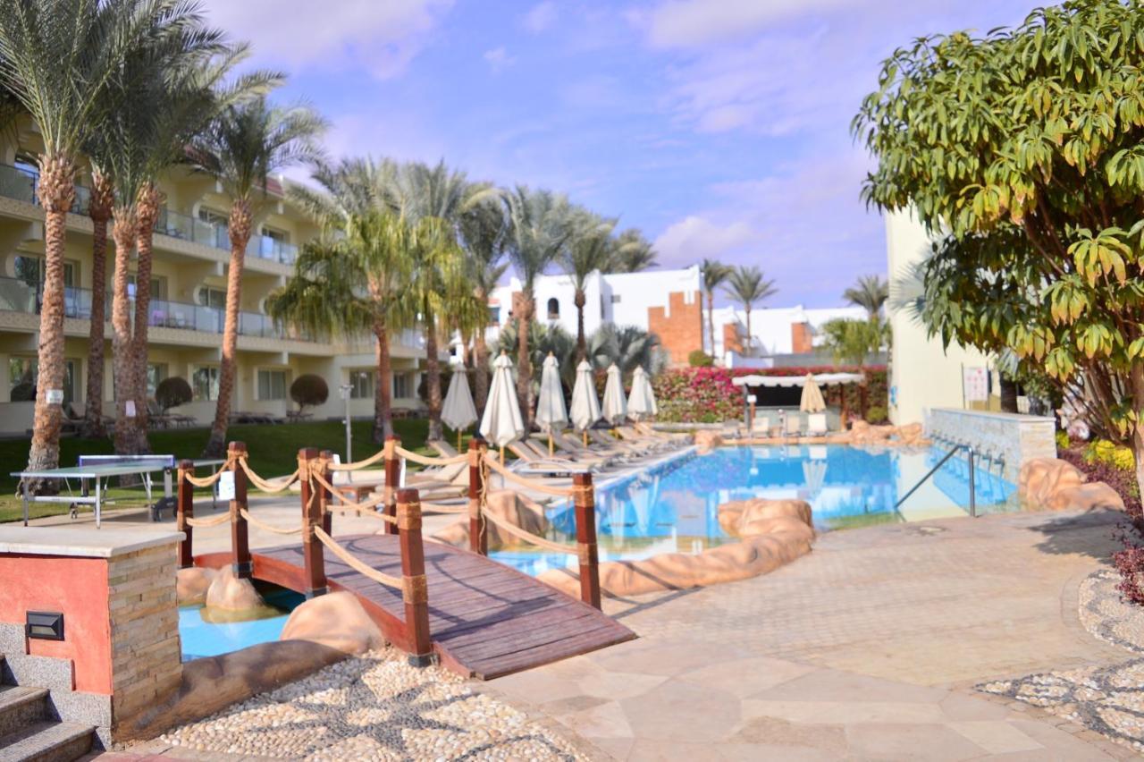 Xperience Sea Breeze Resort Sharm el-Sheikh Exterior foto A pool at a resort in Sharm El Sheikh